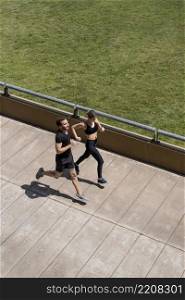 man woman jogging together outdoors