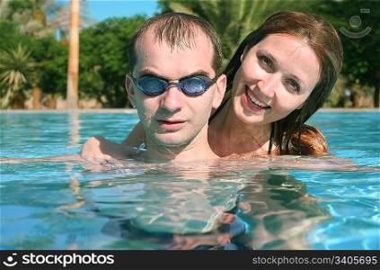 man woman pool tropical