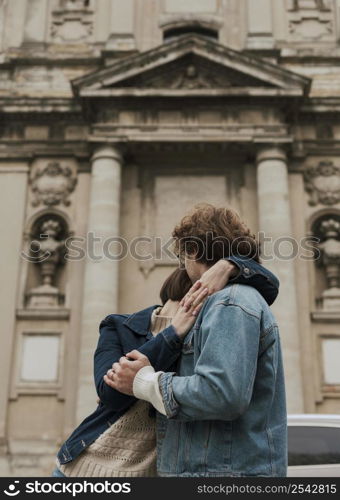 man woman posing hugged