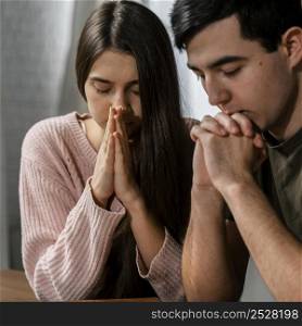 man woman praying together