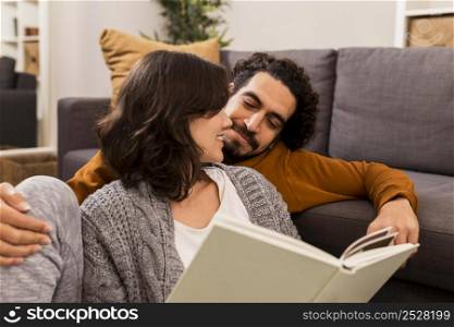 man woman reading together living room