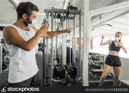 man woman saluting each other gym