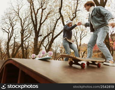 man woman skateboarding outdoors