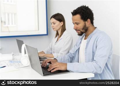man woman typing laptop keyboard