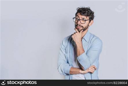 Man wondering with hand on chin on isolated background with copy space, Person wondering with hand on chin seeing blank space