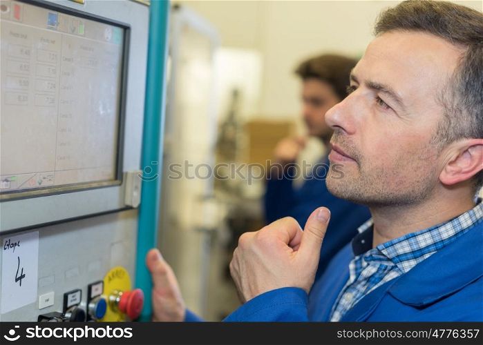 man worker checking advanced industrial control panel