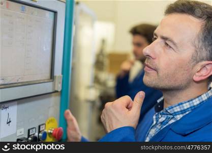 man worker checking advanced industrial control panel