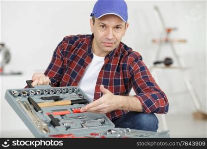 man worker displaying his workplace and tools