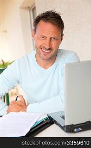 Man working at home on laptop computer