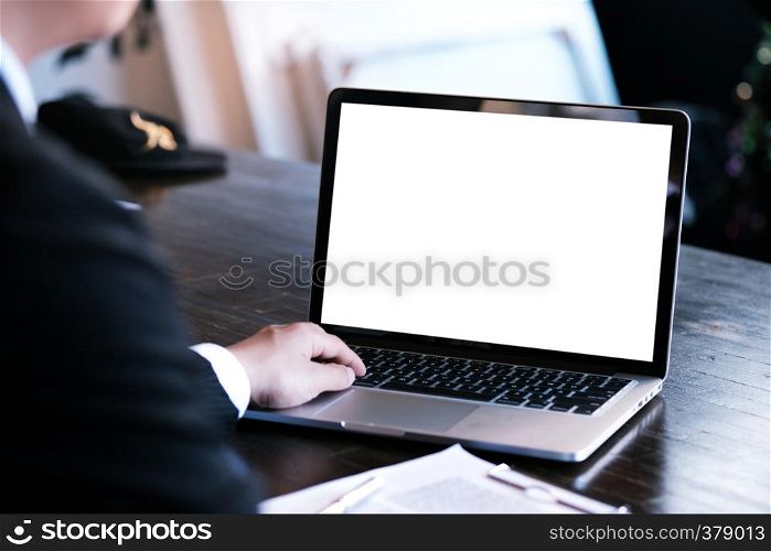 Man working by using a laptop computer on wooden table. Hands typing on a keyboard