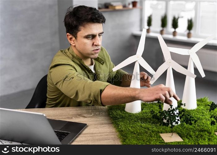 man working eco friendly wind power project with wind turbines
