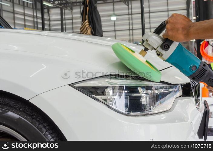 Man working for polishing, coating cars. polishing of the car will help eliminate contaminants on the surface of the car.Waxing the car surface will cause shine after polishing the car.