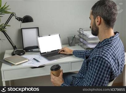 man working from home while having coffee