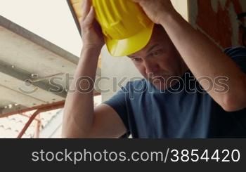 Man working in construction site, manual worker with safety helmet and work equipment. Part 2 of 8