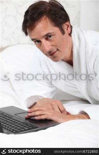 Man working in dressing gown.