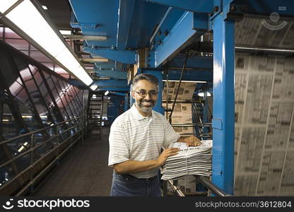 Man working in newspaper factory