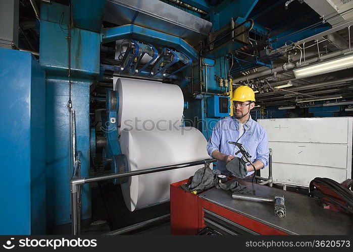 Man working in newspaper factory