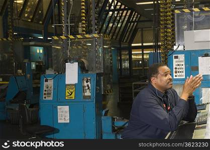 Man working in newspaper factory