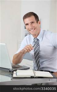 Man working in the office with laptop computer