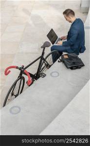 man working laptop his bike 2