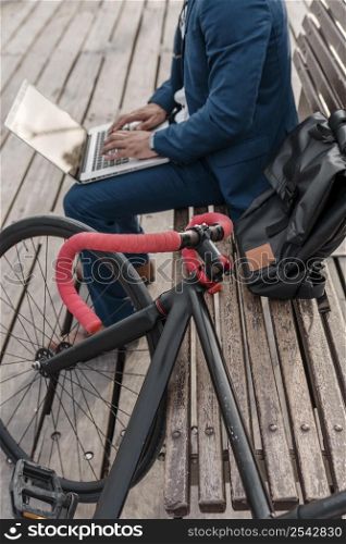 man working laptop his bike outside 2