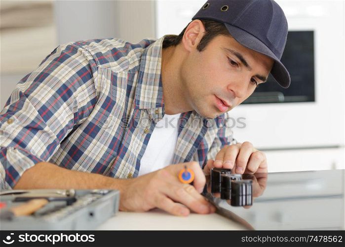 man working on a new kitchen installation