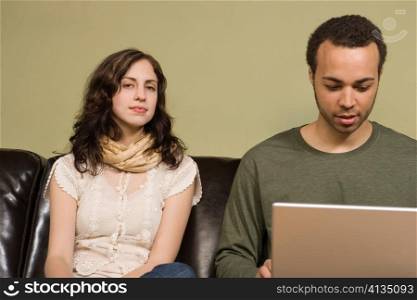 Man Working on Computer while Woman Looks On