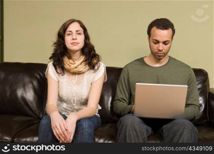 Man Working on Computer while Woman Looks On