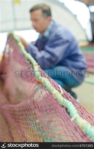 Man working on fishing net