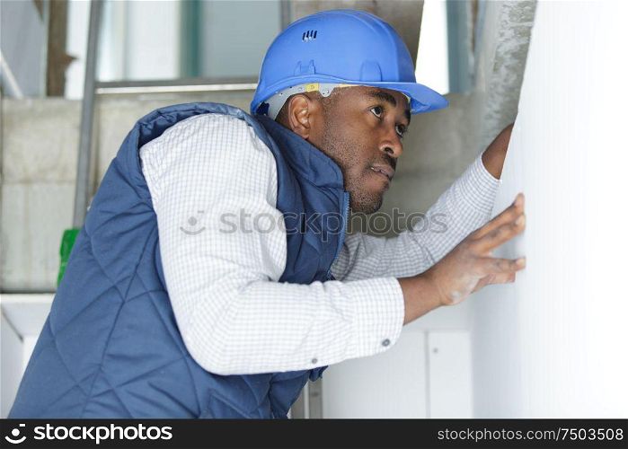 man working on upper window