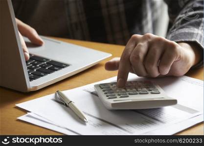 Man Working Out Household Finances