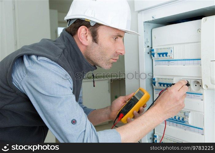 man working using multimeter electrician concept