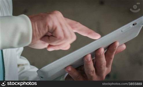 Man Working With A Tablet. Close-Up RAW Video