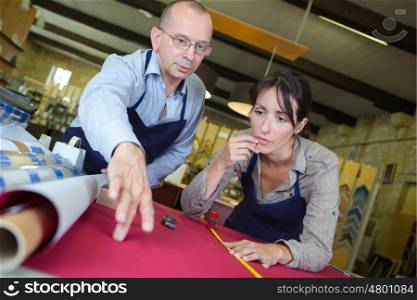 man working with apprentice in wharehouse