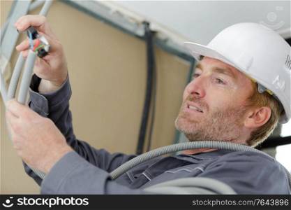 man working with cables indoors