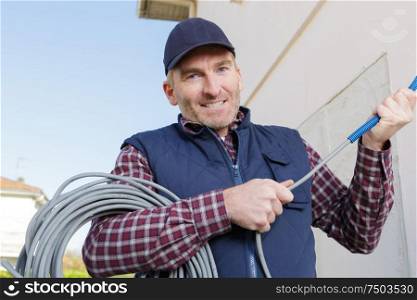 man working with cables outdoors