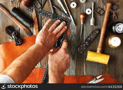 Man working with leather using crafting DIY tools