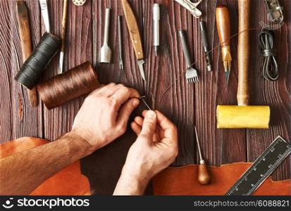 Man working with leather using crafting DIY tools