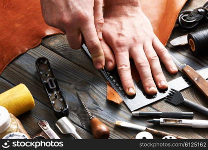 Man working with leather using crafting DIY tools