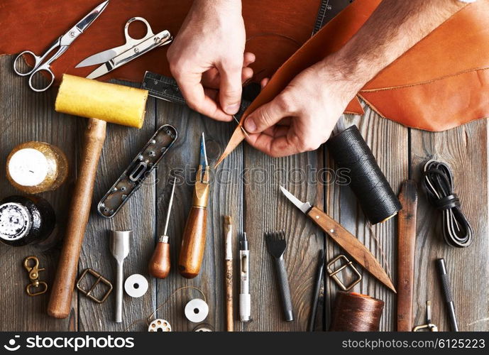 Man working with leather using crafting DIY tools