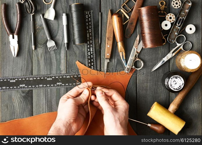 Man working with leather using crafting DIY tools