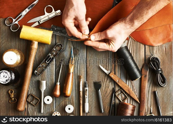 Man working with leather using crafting DIY tools