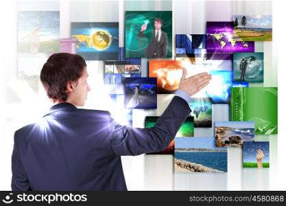 Man working with vurtial screens with different images