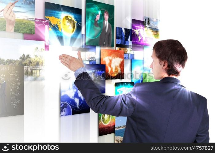 Man working with vurtial screens with different images