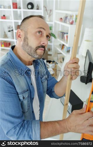 man working with wood at home
