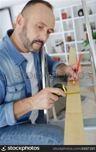 man working with wood in the home