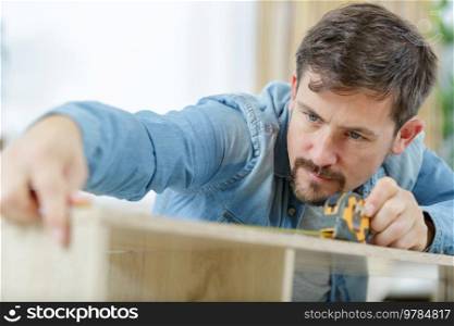 man working with wood measuring tape