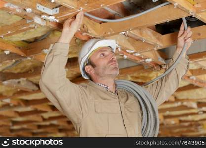 man working with wood structure