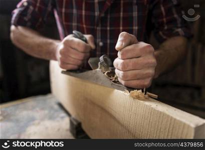 man working with wood workshop