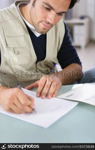 Man writing on a piece of paper